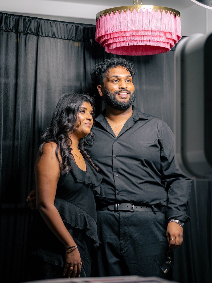 The couple posing together at the Manjal photo booth