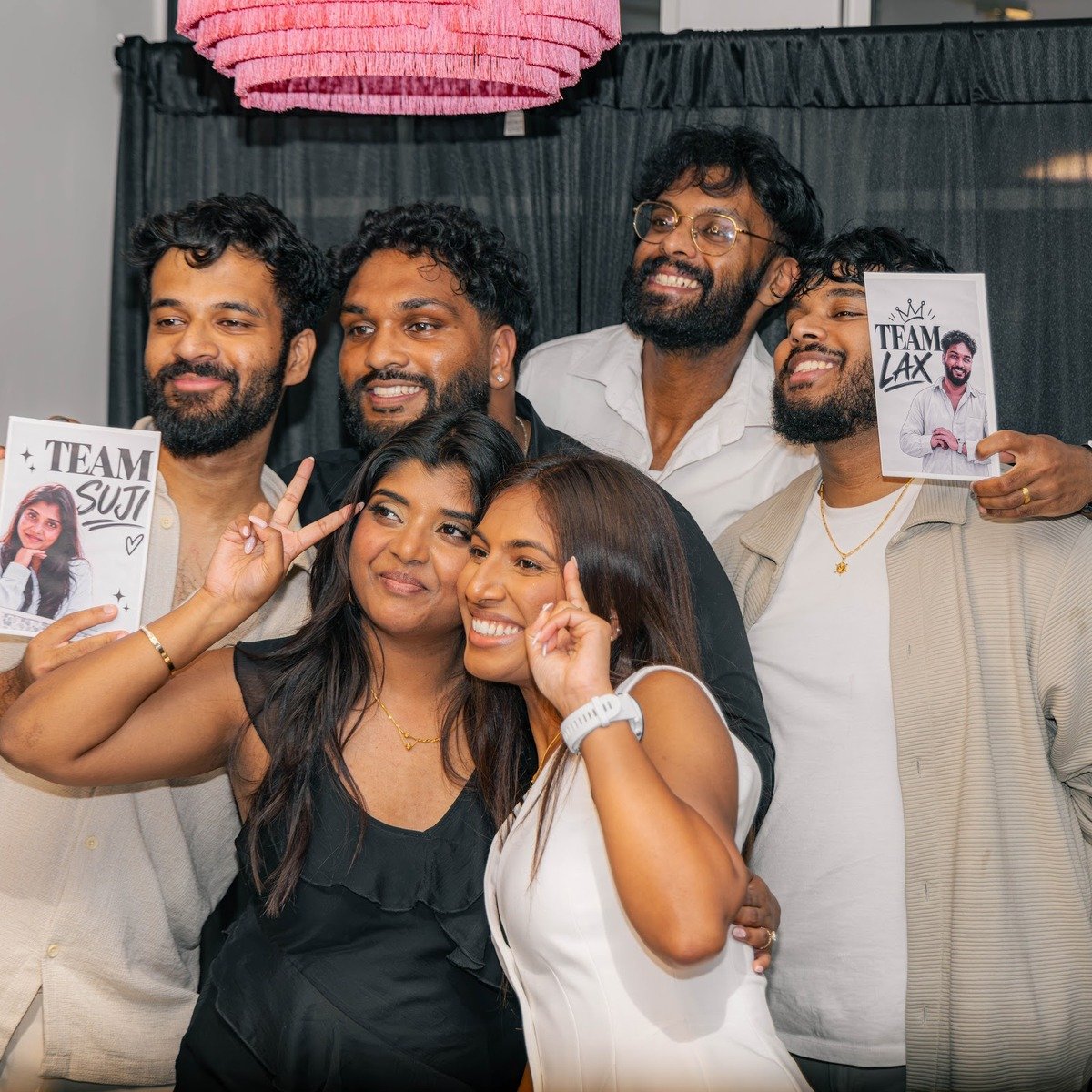 Guests at the Manjal photo booth with props and signs