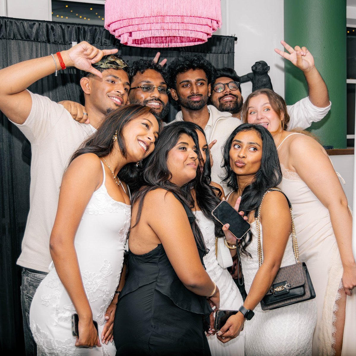 A group of guests posing together at the Manjal photo booth